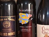 several bottles of wine are lined up on a table