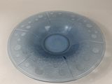 a blue bowl on a table with a white background