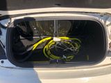 the trunk of a car with a bunch of hoses in it