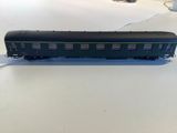 a black train car sitting on a white table