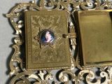 a gold picture frame with a picture of a woman on it