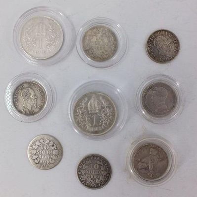 six different types of coins in plastic containers on a white surface