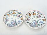 three plates with different designs on them sitting on a table