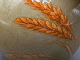 a vase with a painting of a wheat on it