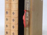 two books that are open to show a red bird