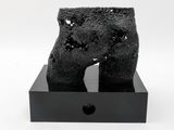 a black sculpture that is on top of a black box