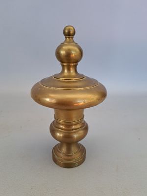 antique brass candle holder with a round top