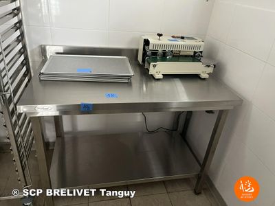 a table with a pan on it and a machine on it