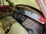 an old car with a leather seat and a steering wheel