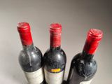 three bottles of wine sitting next to each other on a table