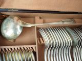 a box full of silverware with a spoon and a ladle in it