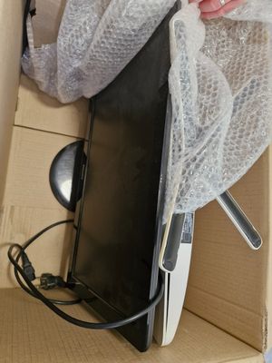 a person that is opening a box with a laptop in it