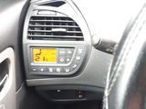 a car dashboard with a digital clock on it