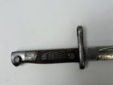 a close up of a knife on a white surface