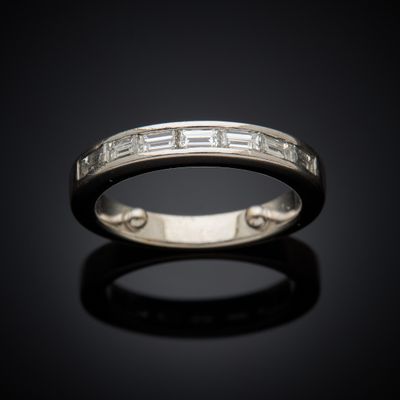 a close up of a wedding ring on a black surface