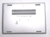 a silver laptop that is sitting on a white surface