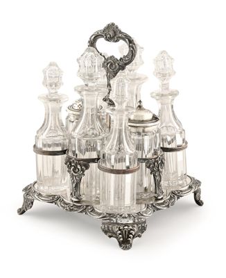 silver plated wine decanter set with six bottles and a stand