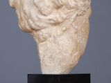 an image of a sculpture of a head on a wooden table
