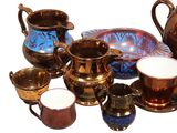 many cups and saucers that are sitting on the table
