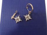 a pair of earrings on a blue background