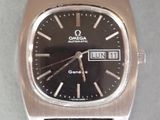 a silver watch with a black face on a black leather strap