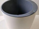 a black and white bowl sitting on a white table
