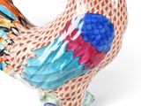 a figurine of a colorful rooster on a white background
