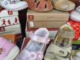 many different types of baby shoes in a pile