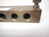 a close up of a brass plate with three holes on it