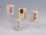 five small cards on display on a clear surface