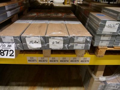 many stacks of boxes on a shelf in a store