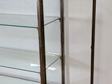 a display case with glass shelves in the corner of a room