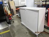 an image of a white refrigerator in a warehouse