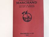 the book is open on a white surface with a red cover