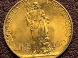 a close up of a gold coin with a statue on it