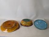 three plates sitting on a table with a white background