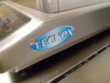 a close up of a machine that has a teconix logo on it
