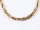 a close up of a gold necklace on a white background