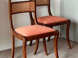 two chairs sitting next to each other in a room