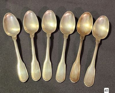 six silver spoons are lined up in a row on a black surface