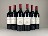 six bottles of red wine lined up in a row on a table