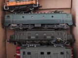 a lot of toy trains sitting on top of each other in a box