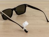 sunglasses on a wooden table with a price tag on it