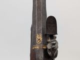 wooden sculpture of a man holding a knife and a book on a table