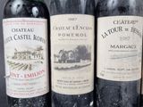 three bottles of wine are lined up on a table