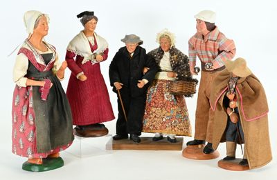 five figurines of people dressed in traditional clothing