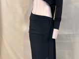 a mannequin with a black top and skirt on a mannequin stand