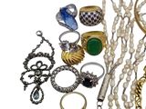 a lot of jewelry that is laying out on the table