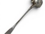 a spoon with a spoon handle on a white surface