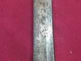 a close up of a knife on a red cloth